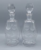 A pair of Bohemian glass decanters, each etched with pheasants within landscapes, 26cms tall