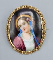 An oval painted porcelain brooch with yellow metal frame, 4cms by 5cms,