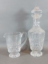 A Waterford Tramore pattern glass decanter, 32cms tall together with a matching jug