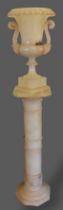 An early 20th Century Alabaster Jardiniere and stand, the two handled jardiniere upon a Torchere,