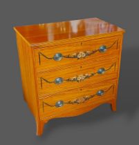 A Sheraton revival Satinwood chest, the reeded top above three drawers painted with bows and swags