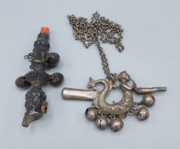 A 19th Century silver babies rattle with coral mount together with a similar whistle