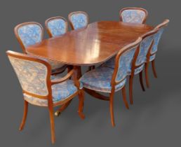 A Regency style dining suite comprising eight chairs and an extending dining table with single extra