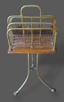 An Edwardian brass revolving paper rack with paw feet