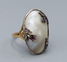 A 22ct gold Art Nouveau style ring set with mother of pearl and decorated with Ruby, Sapphire and