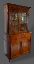 A Regency mahogany secretaire bookcase, the moulded cornice above two astragal glazed doors