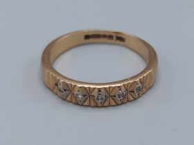 A 9ct gold ring set with five Diamonds, ring size M, 2.2gms