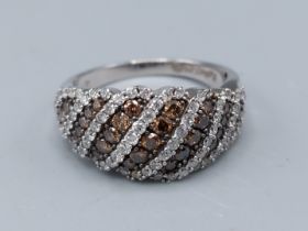 A 14ct white gold chocolate diamond and diamond band ring, ring size N