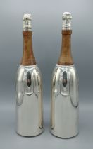 A pair of silver plated and wooden cocktail shakers in the form of champagne bottles, 37cms tall