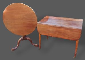 A 19th Century mahogany tilt top table with a turned centre column and pad feet together with a 19th