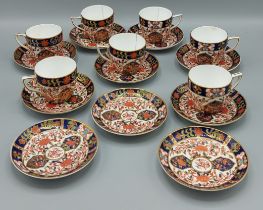 A Royal Crown Derby coffee service comprising seven cups and ten saucers all decorated in the