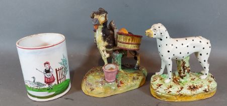 A Staffordshire model of a Donkey with Panniers together with a Staffordshire model of a dog and