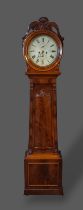 A William IV mahogany longcase clock, the circular hood with carved cresting above a tapering door