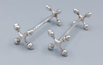 A pair of London silver knife rests, decorated with acorns, 3ozs