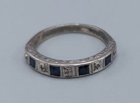 An 18ct white gold Sapphire and Diamond set half eternity ring, ring size M, 3.5gms