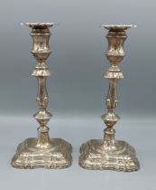 A pair of Edwardian silver candlesticks with shaped stepped bases, Sheffield 1906, 24cms tall