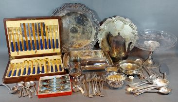 A silver plated entree dish together with other plated items