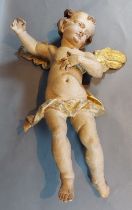 A 18th/19th century carved and polychrome decorated model in the form of Putti, 48cms tall