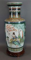 A 19th Century Chinese vase decorated with figures amongst foliage with polychrome enamels