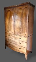 A Regency mahogany press cupboard, the moulded cornice above two doors enclosing a hanging space,