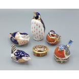 A Royal Crown Derby Emperor Penguin paperweight with gold stopper, together with four other