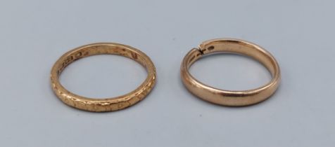 A 22ct gold wedding band, 2.7gms together with a 9ct band ring 2.2gms