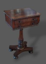 A William IV Rosewood worktable with two drawers above a turned centre column raised upon a platform