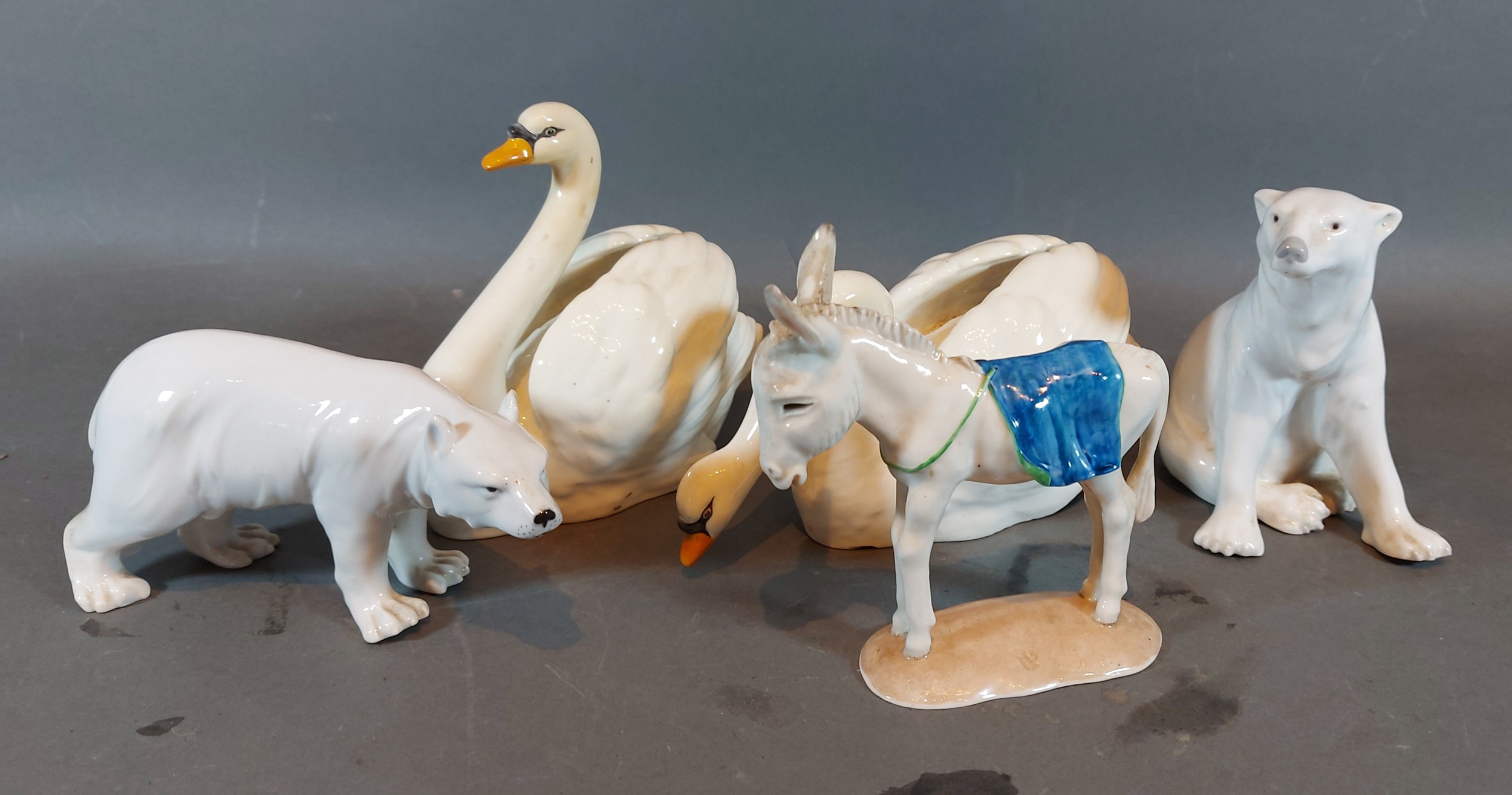 A Minton porcelain model in the form of a swan together with another similar, a Nymphenburg model of