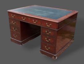 A Victorian mahogany twin pedestal desk, the moulded top above nine drawers with brass handles