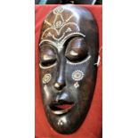 African Tribal Mask inlaid with mother of pearl and three Chinese coins. An decorative piece