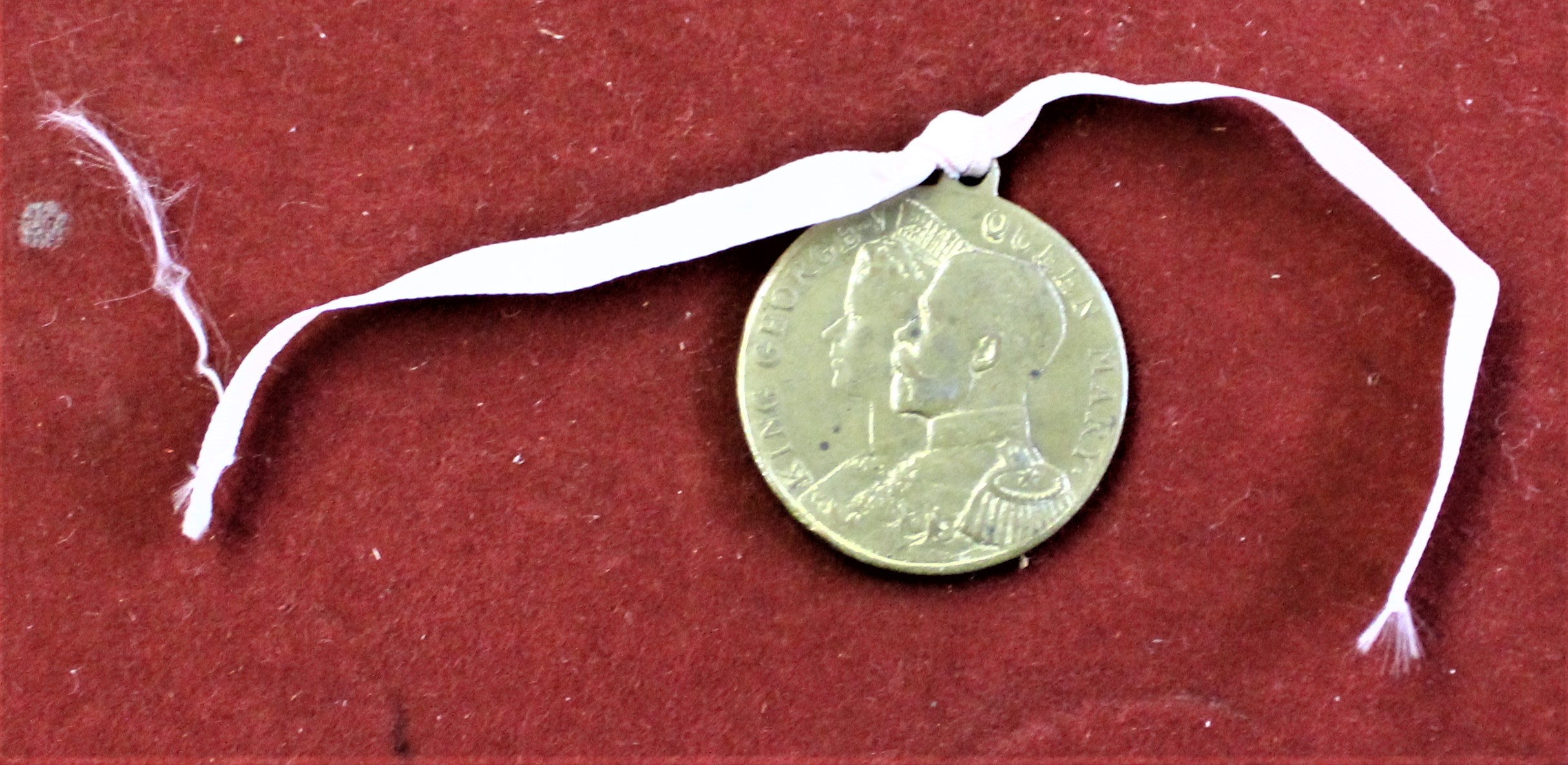 George V 1911 Coronation medallion, which has been struck by 'The Makers of Elect Cocoa' to