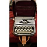 Typewriter-A 'Royalite' Typewriter in brown case (Portable) in working order