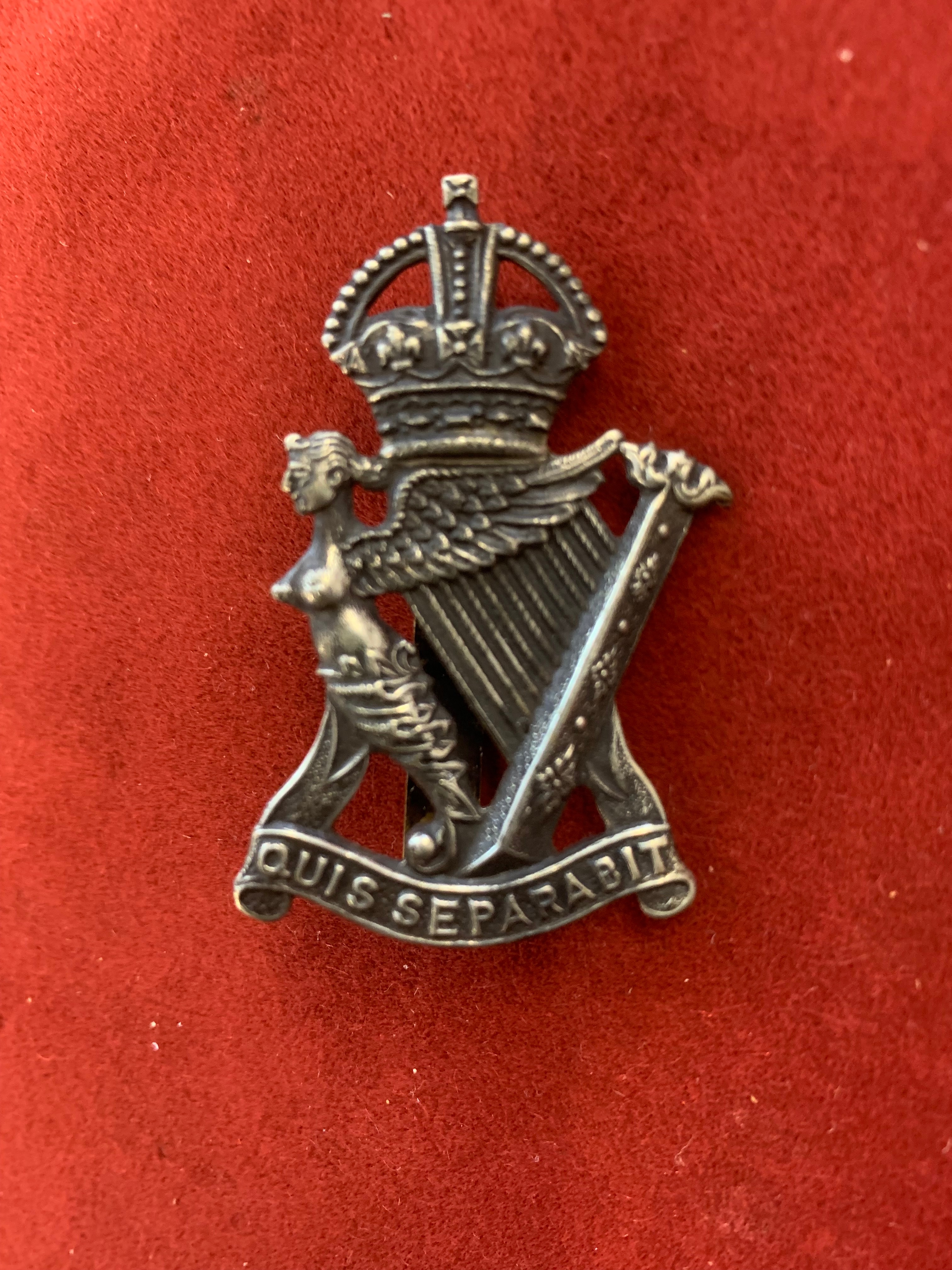 British WWII Royal Irish Rifles cap badge, white-metal and slider.