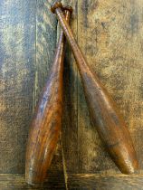 A pair of Indian clubs for juggling, Victorian exercise batons. (2)