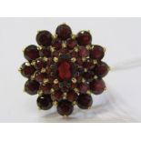 IMPRESSIVE LARGE GARNET CLUSTER RING, principal oval cut garnet surrounded by kencentric ovals of