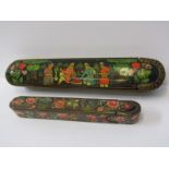 EASTERN PEN CASES, 2 painted papier mache pen cases, 1 with family group decorated lid, 25cm length