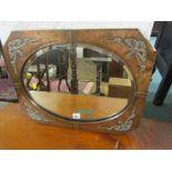 ARTS & CRAFTS, a hammered copper surround oval bevel edge mirror with ribbon relief decoration, 53cm