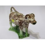 WHIELDON-STYLE POTTERY, an antique pottery cow creamer with lid, sponged decoration (some