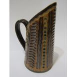 DOULTON LAMBETH, a Frank Butler signed stoneware milk jug, incised and impressed decoration, 18cm