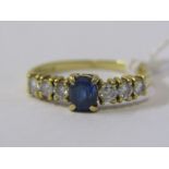 SAPPHIRE & DIAMOND RING, 18ct yellow gold ring, set a central oval sapphire with 3 round brilliant