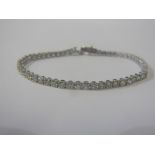 SUPERB DIAMOND LINE BRACELET, 18ct white gold bracelet set 54 well matched round brilliant cut