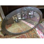ART & CRAFT MIRROR, a crafted copper oval surround, bevel edged mirror, 66cm diameter