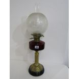 ANTIQUE OIL LAMP, brass column base cut ruby glass reservoir oil lamp with spherical glass shade,