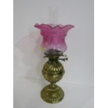 ANTIQUE OIL LAMP, brass fluted circular base oil lamp with cranberry crinoline glass shade, 47cm