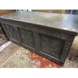 ANTIQUE CARVED OAK COFFER, triple panelled front with geometric carved designs, 125cm width