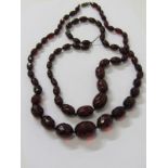 2 X GRADUATED CHERRY AMBER NECKLACES, 1 faceted, other plain, combined weight approx 86.3 grams