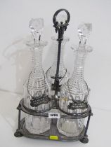 VICTORIAN DECANTER SET, a plated 3 bottle stand containing 3 cut glass decanters with multi rimmed