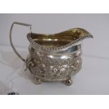 GEORGE III SILVER CREAM JUG, rectangular form with embossed floral & scroll design, London 1812,