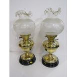 OIL LAMPS, a pair of brass circular base oil lamps with decorative crinoline glass shades