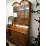 GEORGIAN DESIGN FIGURED MAHOGANY BUREAU BOOKCASE, made by Arthur Brett & Son Limited, twin domed top